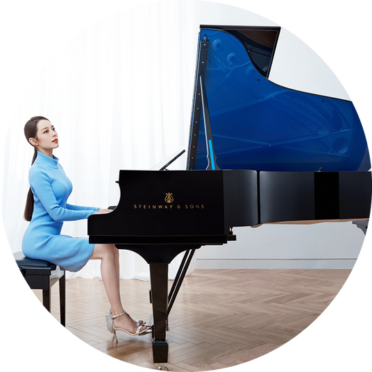 Lady playing a Steinway & Sons Grand Piano