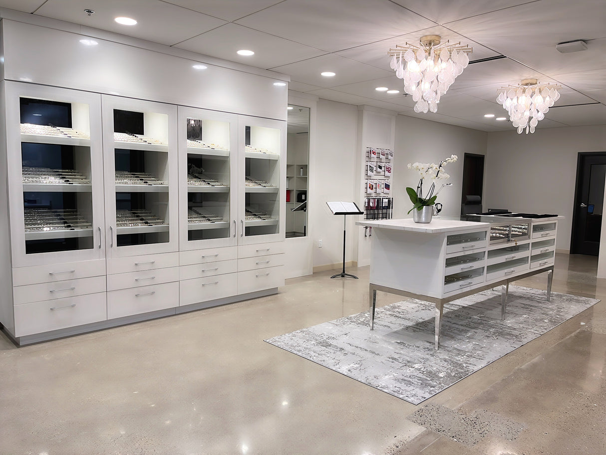 The Flute Gallery is a bright space with a cabinet filled with intermediate and professional level flutes, and a center island for flute headjoints