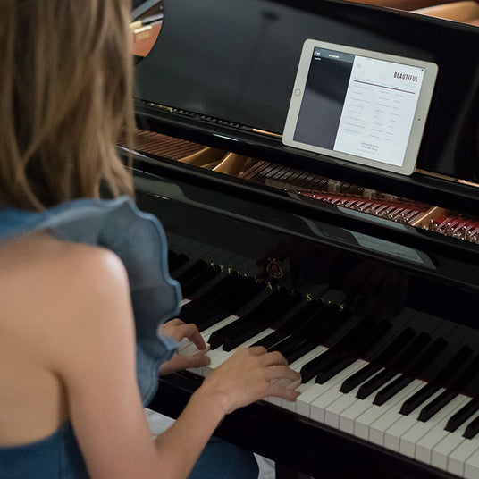 Women playing on a Steinway Spirio piano