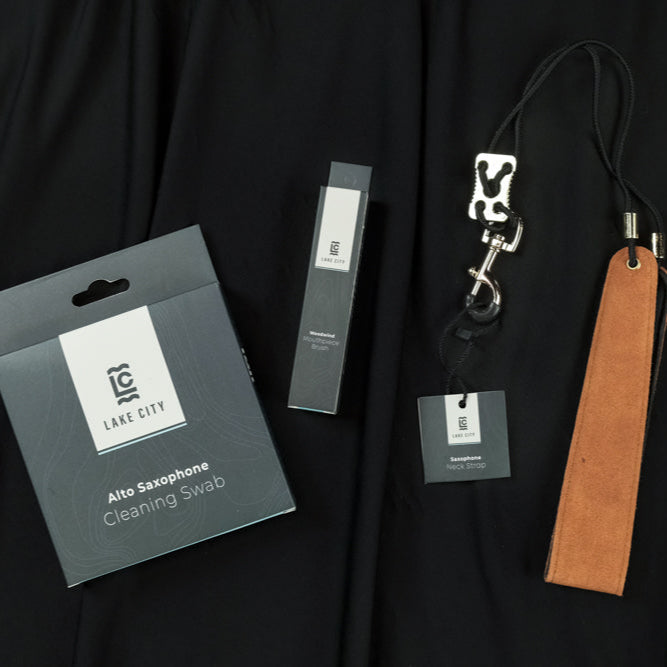 The Lake City Alto Saxophone bundle. Includes a cleaning snake, a mouthpiece brush, and a neck strap.