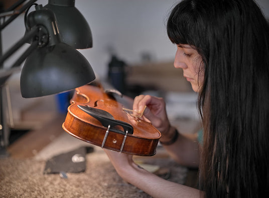 Luthier Isabel working on a violin