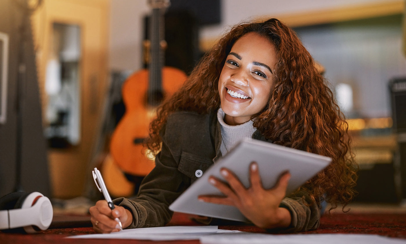 Music teacher and tablet. Guitar in background.