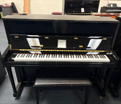 Black upright piano in a showroom setting