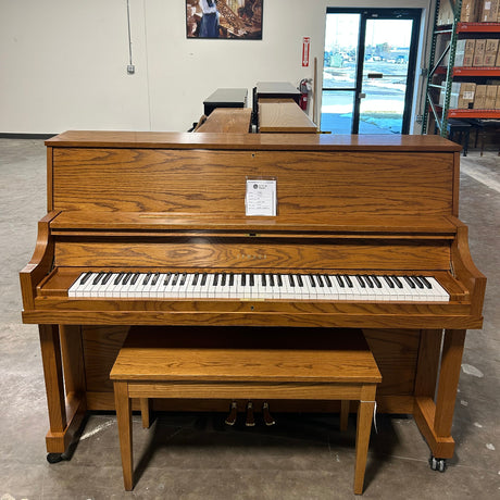 Oak Piano and bench in Warehouse.