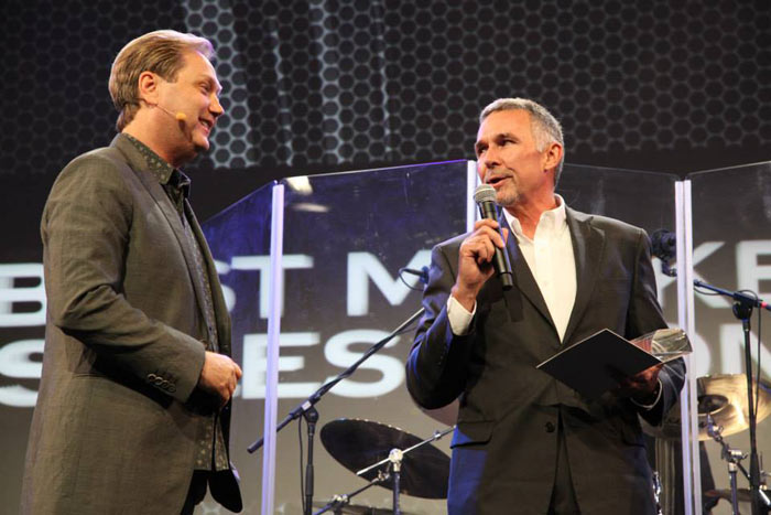 Tom Schmitt receives an award from host Steve Wariner